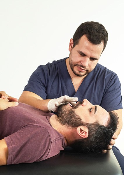 Orthopedic doctor performing jaw examination